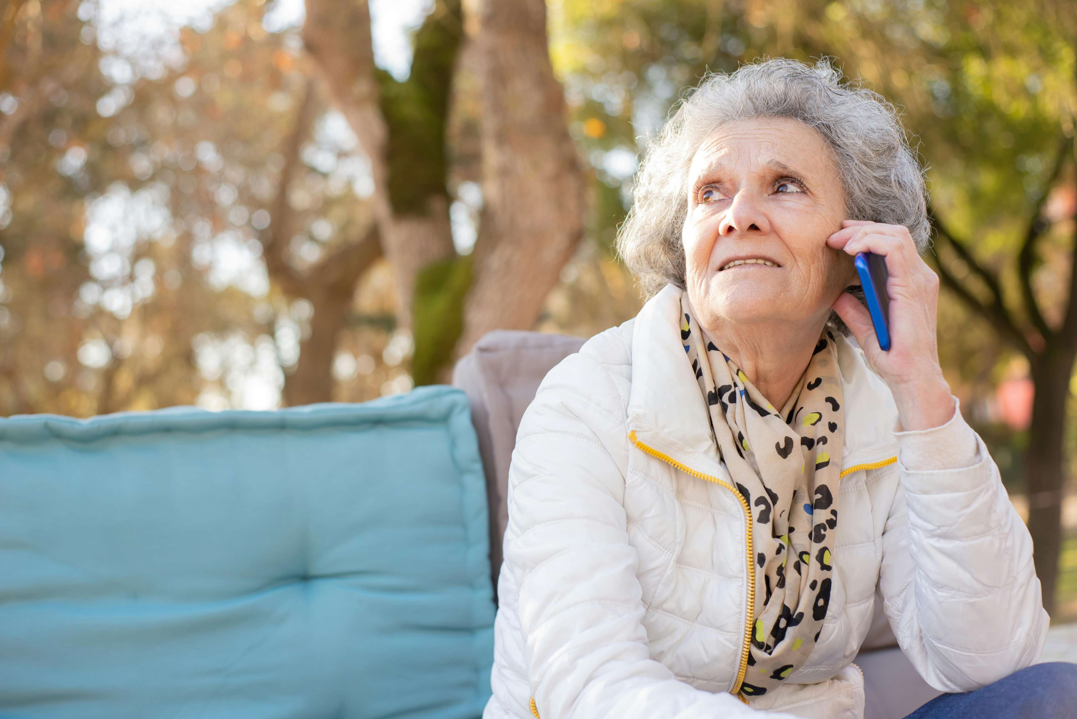 Elderly person happily talking on the phone